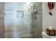 Modern shower with decorative tile accents, glass doors and wall-mounted dispenser at 7941 58Th N Ave # 301, St Petersburg, FL 33709