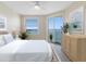 Bright bedroom with a ceiling fan, water view and a private balcony at 7979 Sailboat Key S Blvd # 505, South Pasadena, FL 33707