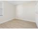 Neutral-toned bedroom featuring light wood floors, a double-door closet and a window to let in light at 7979 Sailboat Key S Blvd # 505, South Pasadena, FL 33707