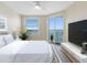Bedroom with sliding glass doors to the balcony, and water views at 7979 Sailboat Key S Blvd # 505, South Pasadena, FL 33707