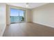 Light-filled bedroom boasts floor-to-ceiling windows with sliding doors leading to a private balcony at 7979 Sailboat Key S Blvd # 505, South Pasadena, FL 33707