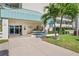 Well-maintained Sunrise Two building entrance, featuring lush landscaping, shade, and covered entry at 7979 Sailboat Key S Blvd # 505, South Pasadena, FL 33707