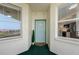 Condo entrance door with flower welcome mat, bay window and glimpse of the interior at 7979 Sailboat Key S Blvd # 505, South Pasadena, FL 33707
