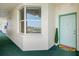 Exterior view of the condo unit's entrance with bay window and blue-green painted door at 7979 Sailboat Key S Blvd # 505, South Pasadena, FL 33707
