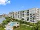 Beautiful waterfront condo building with a swimming pool and lush landscaping at 7979 Sailboat Key S Blvd # 505, South Pasadena, FL 33707