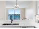Light-filled dining area with water view and stylish chandelier, perfect for elegant meals and gatherings at 7979 Sailboat Key S Blvd # 505, South Pasadena, FL 33707