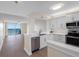 Modern kitchen with stainless steel appliances and views of the spacious living area and the bay at 7979 Sailboat Key S Blvd # 505, South Pasadena, FL 33707