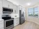 Updated kitchen with stainless steel appliances, stone backsplash, and bright lighting perfect for cooking and dining at 7979 Sailboat Key S Blvd # 505, South Pasadena, FL 33707