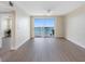 Spacious living room with sliding doors opening to a balcony overlooking the bay and nearby coastline at 7979 Sailboat Key S Blvd # 505, South Pasadena, FL 33707