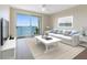 Bright living room with stylish decor and stunning water views from the sliding glass doors to the balcony at 7979 Sailboat Key S Blvd # 505, South Pasadena, FL 33707