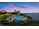 Waterfront pool with lounge chairs for sunning at dusk at 7979 Sailboat Key S Blvd # 505, South Pasadena, FL 33707