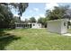 Backyard features a shed, partial fencing, patio, and mature landscaping at 814 W 131St Ave, Tampa, FL 33612