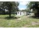 Backyard with home, shed, and patio, enclosed by a white fence at 814 W 131St Ave, Tampa, FL 33612