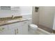 Bathroom with granite countertop, white cabinets, and a tiled shower at 814 W 131St Ave, Tampa, FL 33612