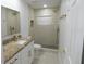 Bright bathroom features granite countertops, white cabinets, and a stand-up shower at 814 W 131St Ave, Tampa, FL 33612
