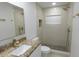 Bright bathroom features granite countertops, white cabinets, and a stand-up shower at 814 W 131St Ave, Tampa, FL 33612