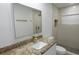Bathroom with granite countertops, white cabinets, and shower with rainfall showerhead at 814 W 131St Ave, Tampa, FL 33612