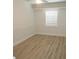Bright bedroom features wood-look flooring, fresh paint, and a window at 814 W 131St Ave, Tampa, FL 33612