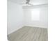 A clean, freshly-painted bedroom with vinyl floors, and a window at 814 W 131St Ave, Tampa, FL 33612