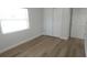 Bedroom features laminate flooring, neutral walls, and a double door closet at 814 W 131St Ave, Tampa, FL 33612