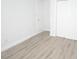 Bedroom with wood-look flooring, white trim, and neutral walls at 814 W 131St Ave, Tampa, FL 33612