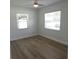 Bedroom with light-colored wood floors, two windows, and white walls at 814 W 131St Ave, Tampa, FL 33612