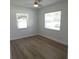 This bedroom has wood-look flooring, fresh paint, and two windows at 814 W 131St Ave, Tampa, FL 33612