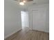 Bedroom with neutral walls, white trim, wood-look flooring, and double door closet at 814 W 131St Ave, Tampa, FL 33612