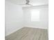 Bedroom with light-colored wood floors, a ceiling fan, and white trim at 814 W 131St Ave, Tampa, FL 33612