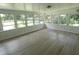 Florida room features wood-look floors and an abundance of windows at 814 W 131St Ave, Tampa, FL 33612