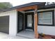 View of the front entrance with custom wood beam and updated hardware at 814 W 131St Ave, Tampa, FL 33612