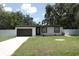 Charming home with lush front lawn, driveway, and a one-car garage at 814 W 131St Ave, Tampa, FL 33612
