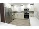 Bright kitchen featuring stainless steel appliances, custom cabinets, quartz countertops, and stylish backsplash at 814 W 131St Ave, Tampa, FL 33612