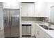 Bright kitchen features stainless steel appliances, white cabinets, and stylish backsplash at 814 W 131St Ave, Tampa, FL 33612