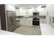 Spacious kitchen with stainless steel appliances, modern cabinetry, and bright quartz countertops at 814 W 131St Ave, Tampa, FL 33612