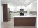 Bright kitchen featuring stainless steel appliances, custom cabinets, and a large breakfast bar at 814 W 131St Ave, Tampa, FL 33612
