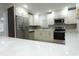 Bright kitchen showcasing stainless steel refrigerator and countertops at 814 W 131St Ave, Tampa, FL 33612
