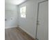 Laundry room with wire shelving and light-colored wood flooring at 814 W 131St Ave, Tampa, FL 33612