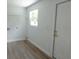 Bright laundry room with vinyl flooring, window, and room for washer and dryer at 814 W 131St Ave, Tampa, FL 33612