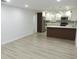 Spacious living area leading into the kitchen featuring gorgeous new flooring at 814 W 131St Ave, Tampa, FL 33612