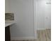 Kitchen area with mosaic backsplash and view to adjacent room with wood-look flooring at 814 W 131St Ave, Tampa, FL 33612
