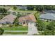 Aerial view showcasing a landscaped property near a pond, highlighting its curb appeal and serene setting at 9126 Cypress Keep Ln, Odessa, FL 33556