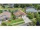 Aerial view showcasing a landscaped property near a pond, highlighting its curb appeal and serene setting at 9126 Cypress Keep Ln, Odessa, FL 33556