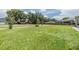 Beautifully maintained backyard with ample green space, mature trees, and a charming picket fence at 9126 Cypress Keep Ln, Odessa, FL 33556