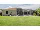 Spacious screened-in lanai with brick patio, perfect for outdoor entertaining in the well-maintained backyard at 9126 Cypress Keep Ln, Odessa, FL 33556