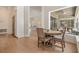 Bright dining area features wood floors, a round table and chairs and a seamless transition to the screened-in lanai at 9126 Cypress Keep Ln, Odessa, FL 33556