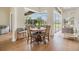 Bright dining area with wood floors, large windows, and screened in patio at 9126 Cypress Keep Ln, Odessa, FL 33556