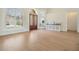 Inviting entryway featuring a bright doorway, with stylish wood doors, large windows, and a light console at 9126 Cypress Keep Ln, Odessa, FL 33556