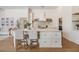 Bright, white kitchen with large island and breakfast bar seating with modern appliances at 9126 Cypress Keep Ln, Odessa, FL 33556