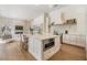 Bright, white kitchen with large island and breakfast bar seating, and stainless steel appliances at 9126 Cypress Keep Ln, Odessa, FL 33556